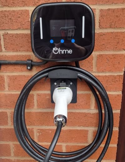 Ohme car charger and holster mount on residential house